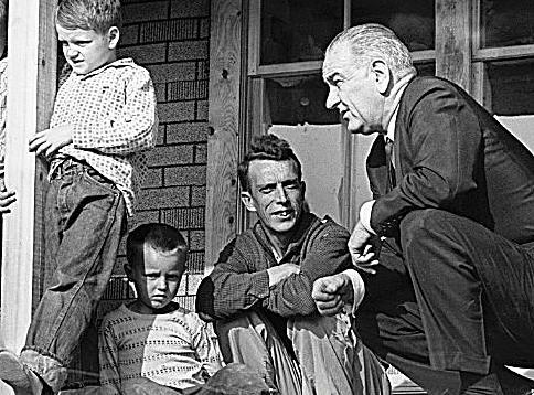 President Johnson visiting a poor rural Kentucky family several months after announcing his "War On Poverty."
